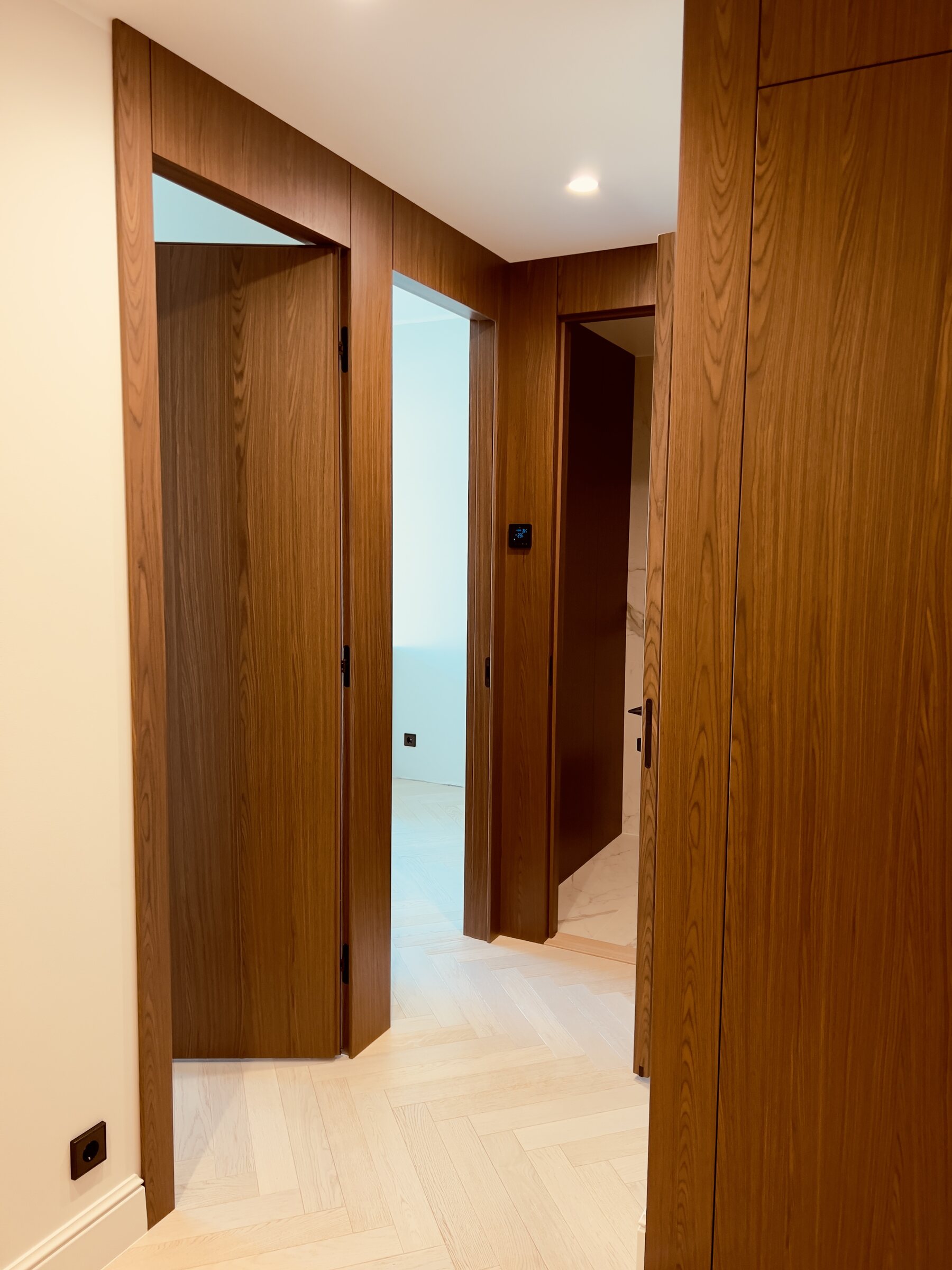 Timber panelled corridor with integrated doors