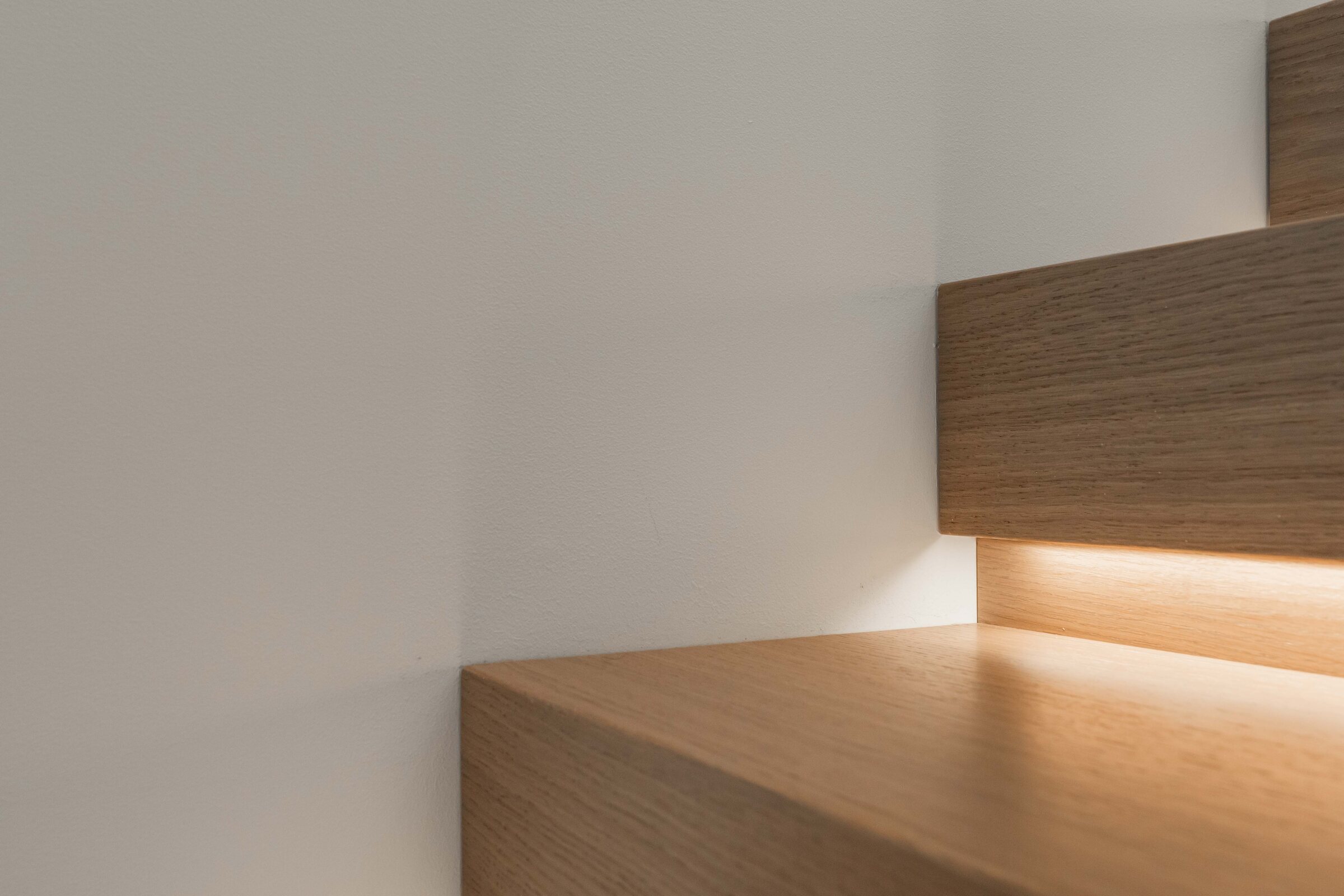 Close-up of integrated oak staircase treads and concealed lighting